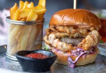 Photograph of a large hamburger, accompanied by a good portion of fries. To illustrate busting the saturated fat causes heart disease myth.